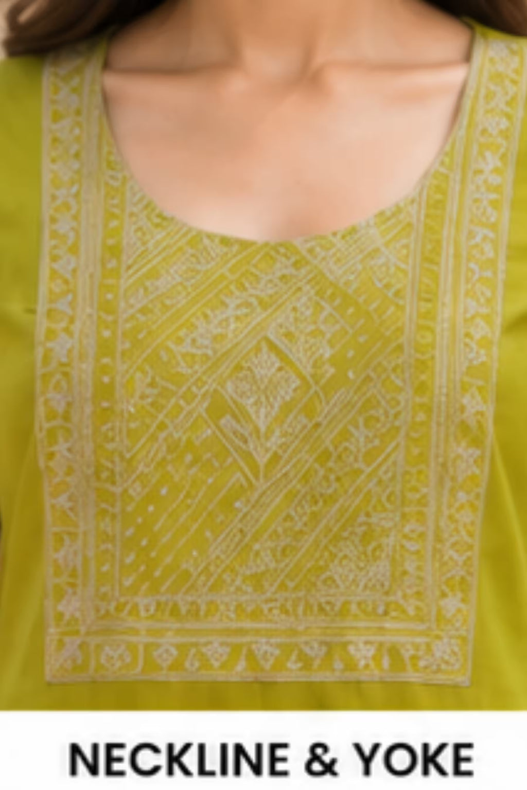 Close-up of a yellow-green kurta neckline with white geometric embroidery