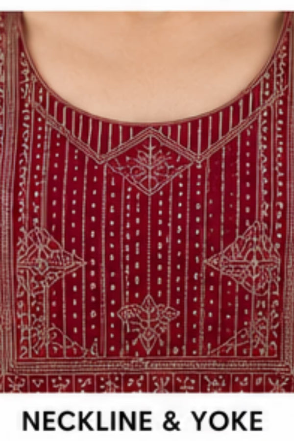 Close-up of a deep red or burgundy neckline and yoke area with intricate metallic embroidery and geometric patterns