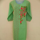 Woman epitomizing grace in a pista green two-tone straight cut kurta with ornate embroidery